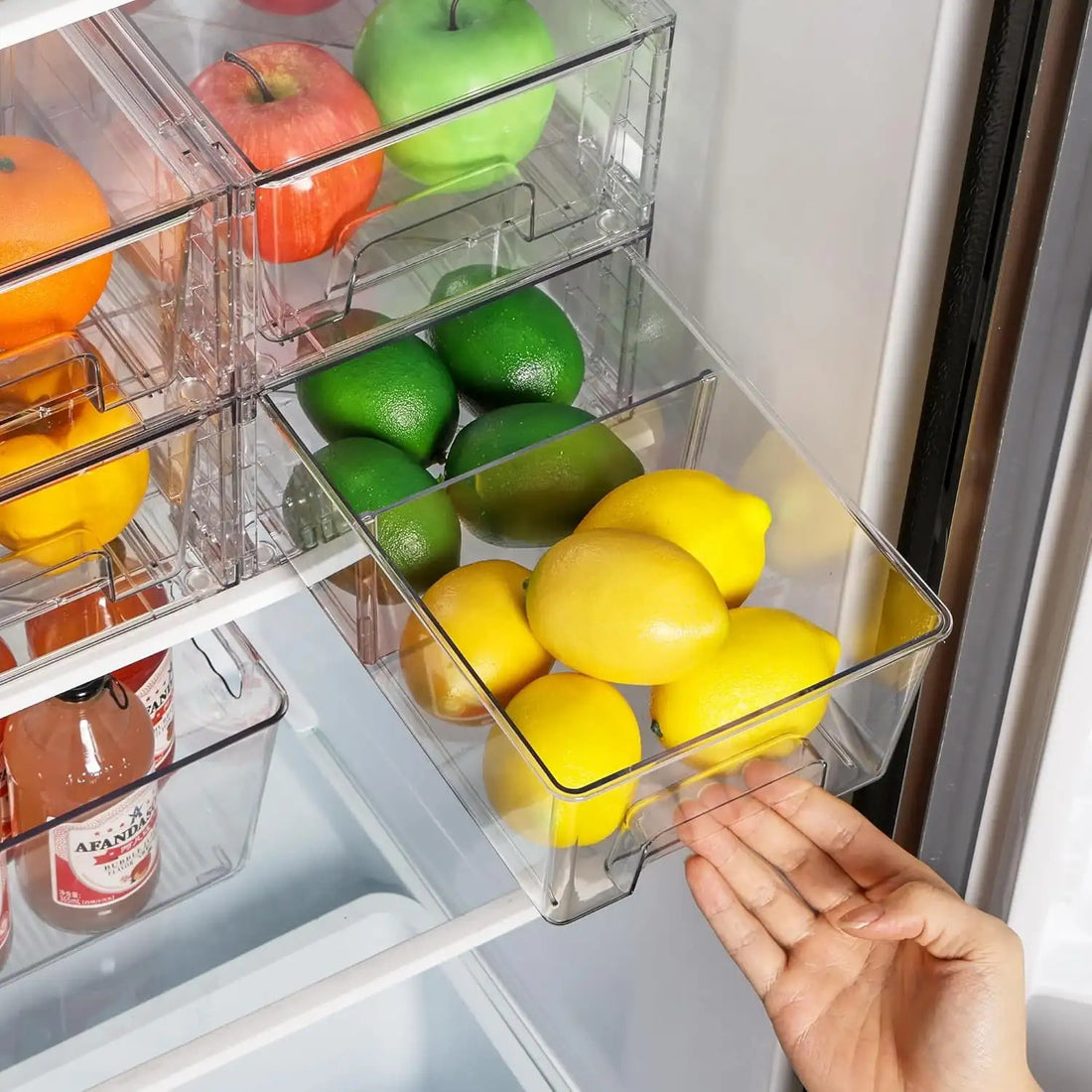 Clear acrylic storage drawers with handles organized in refrigerator with fruits and vegetables