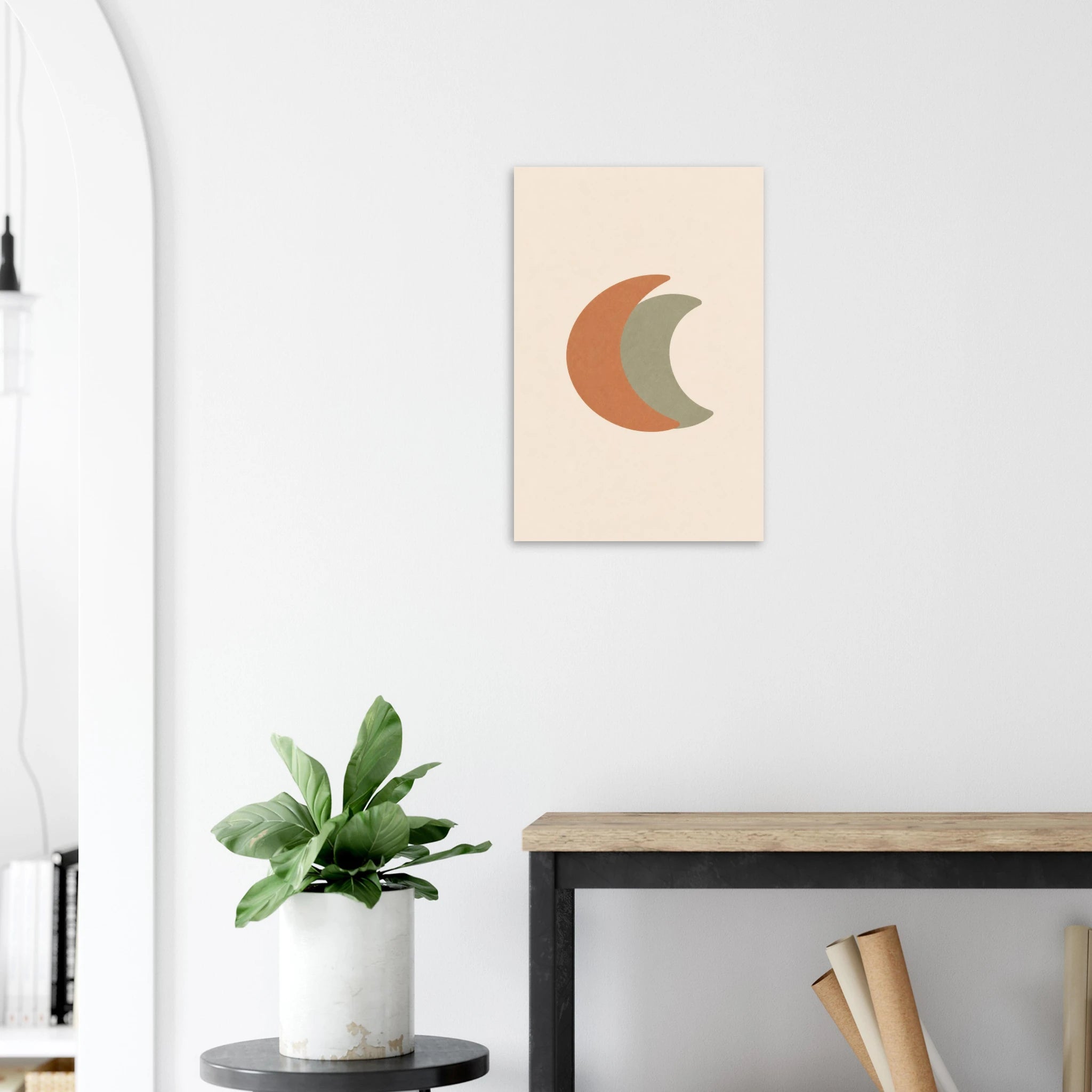 Crescent Moon nursery print on a white wall above a wooden bench with a plant