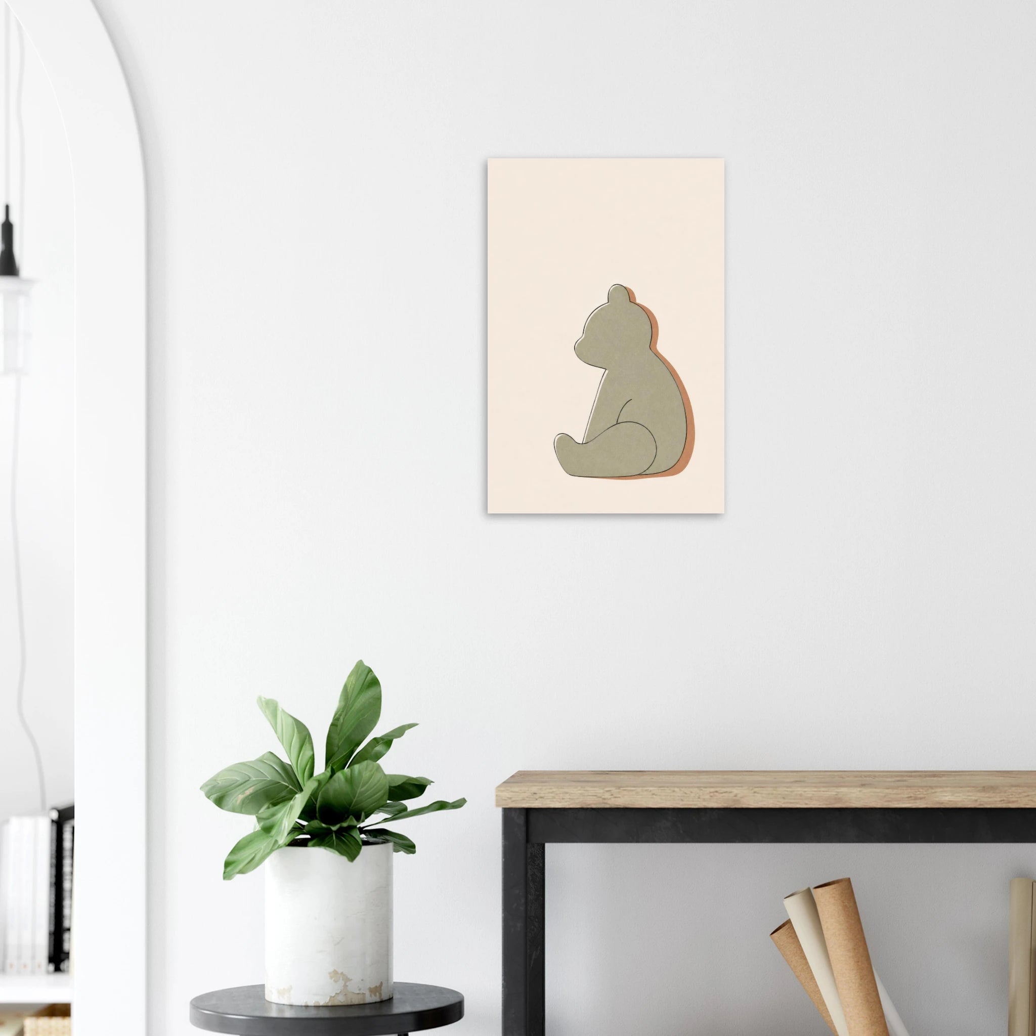 Little Bear nursery print on a white wall above a wooden bench with a plant