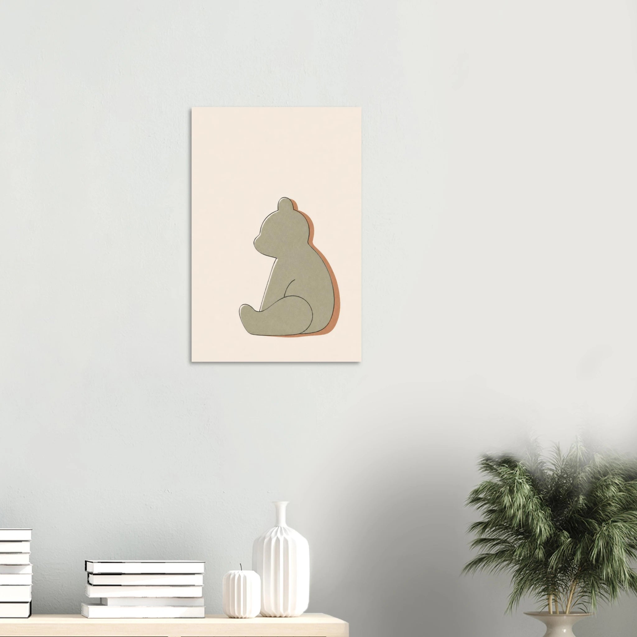 Little Bear nursery print on a white wall above a shelf with books and vases