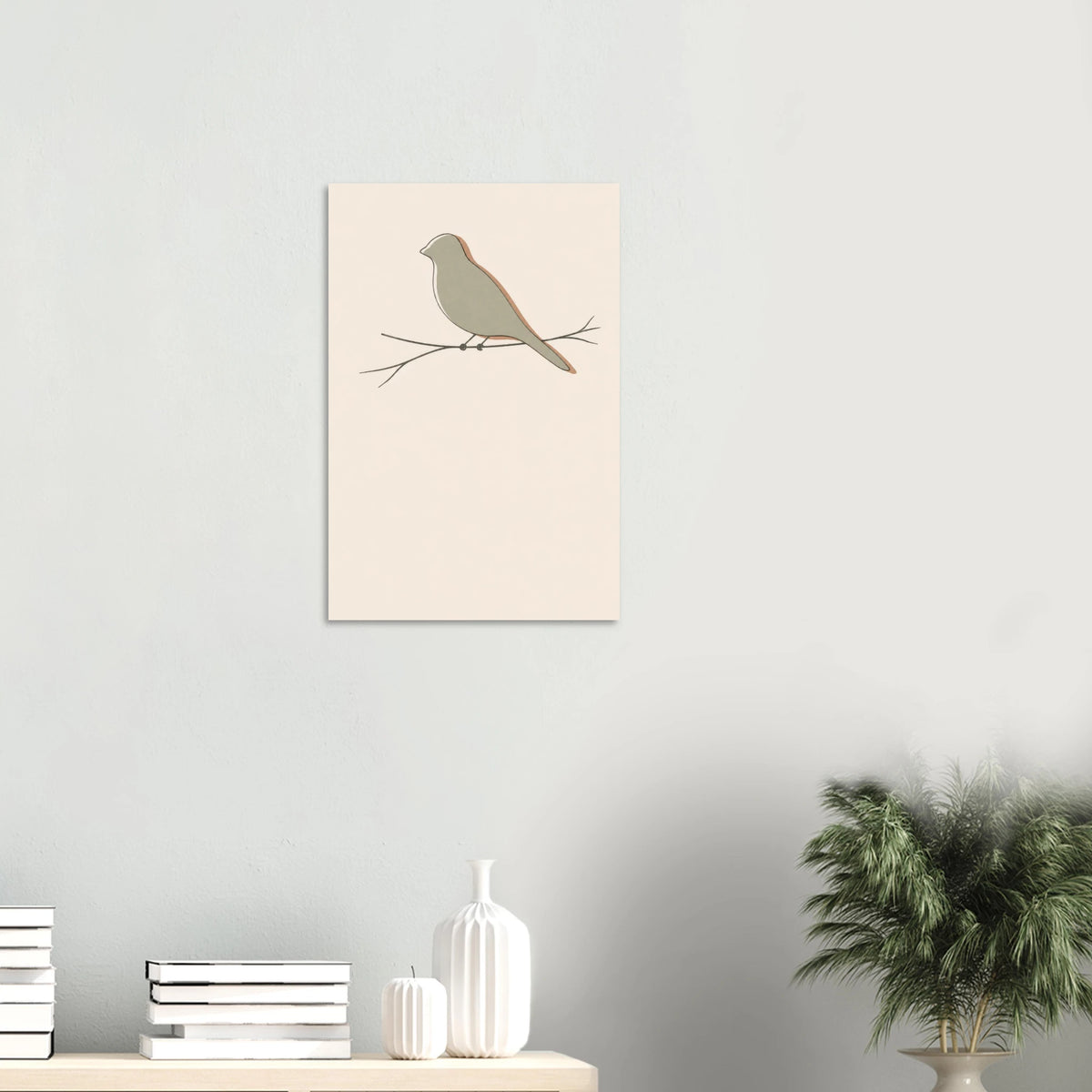 Little Bird nursery print on a white wall above a shelf with books and vases