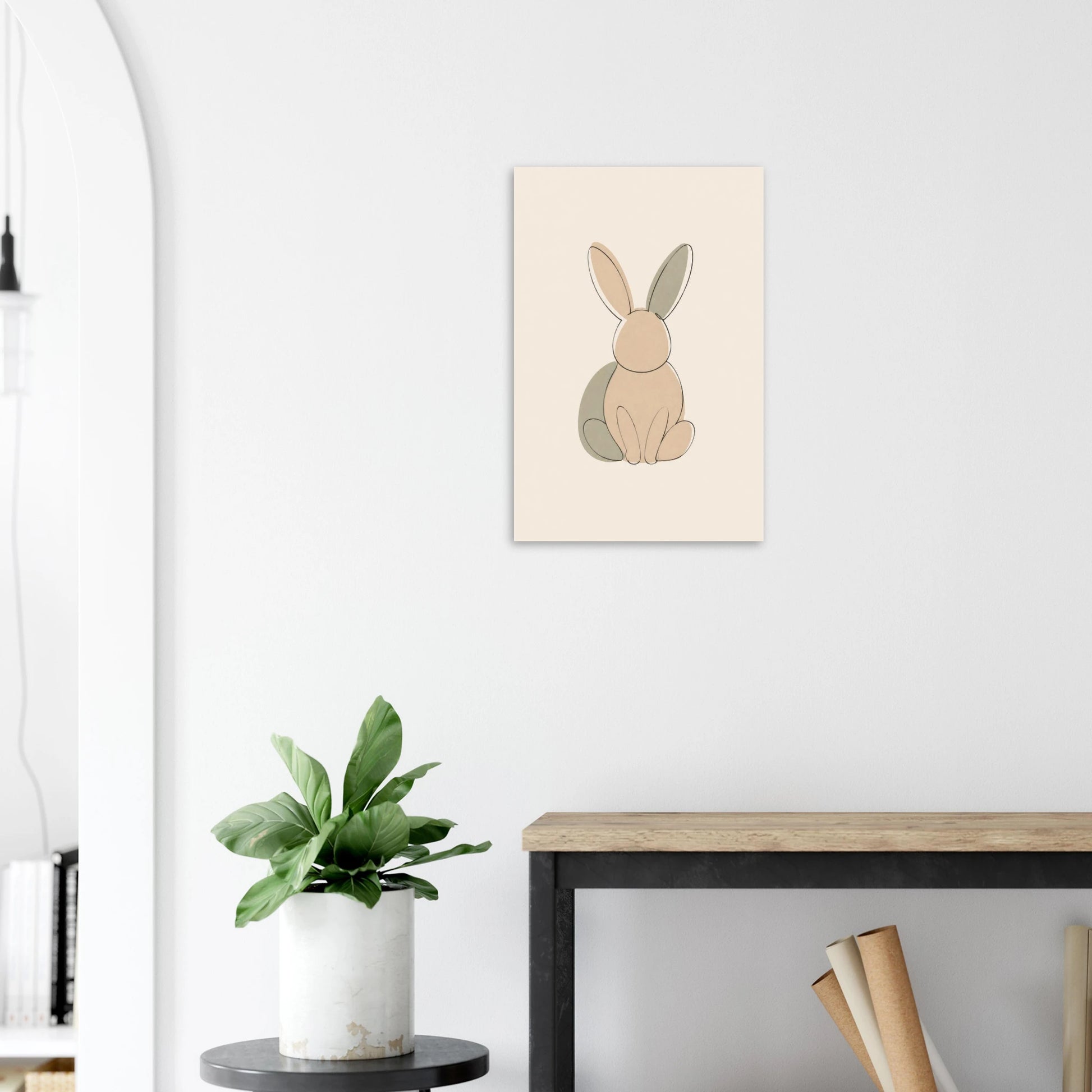 Little Bunny nursery print on a white wall above a wooden bench with a plant