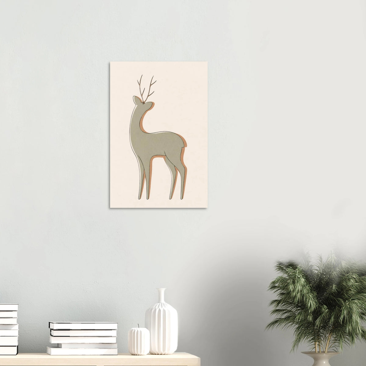 Little Deer nursery print on a white wall above a shelf with books and vases