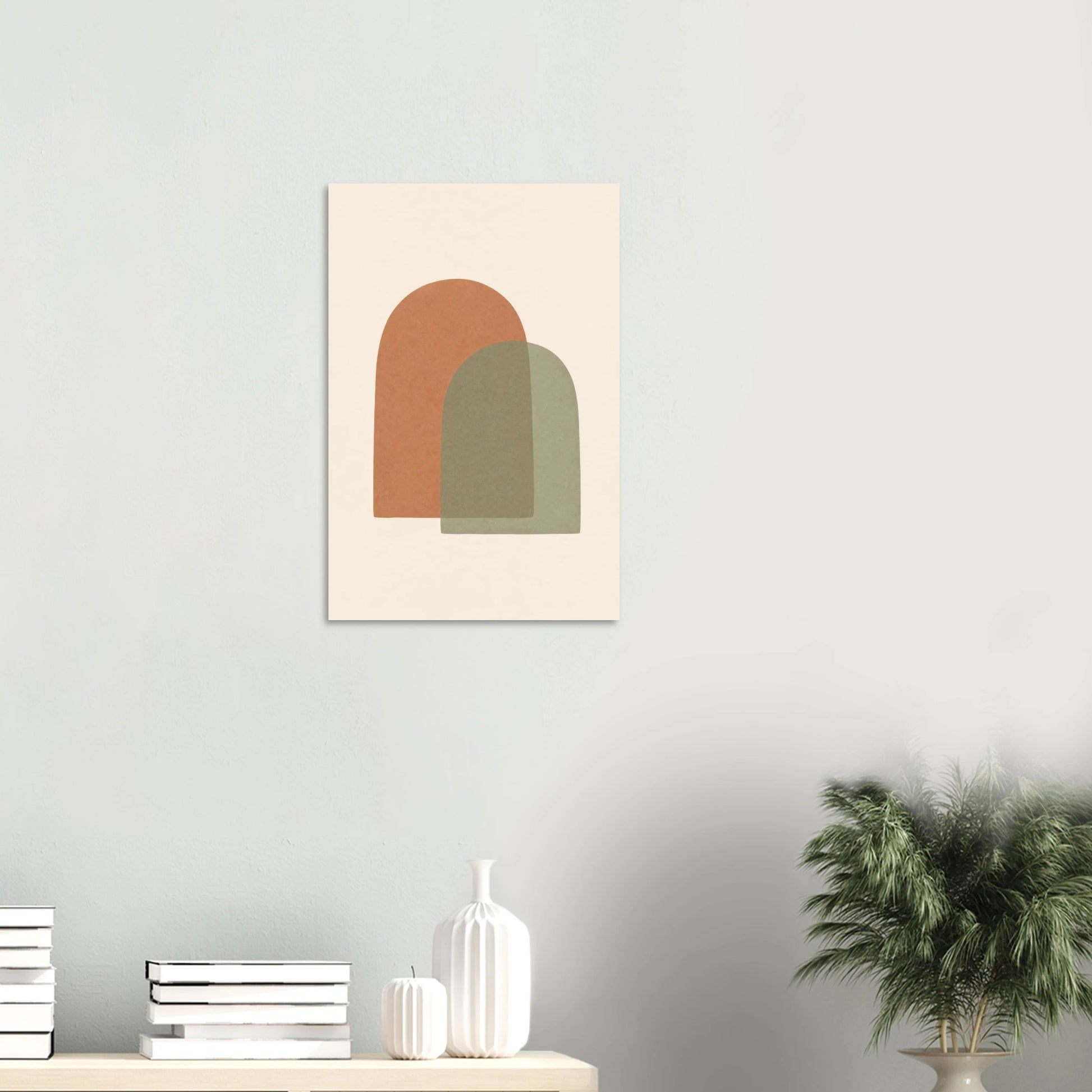 Terracotta & Sage Arches nursery print on a white wall above a shelf with books and vases
