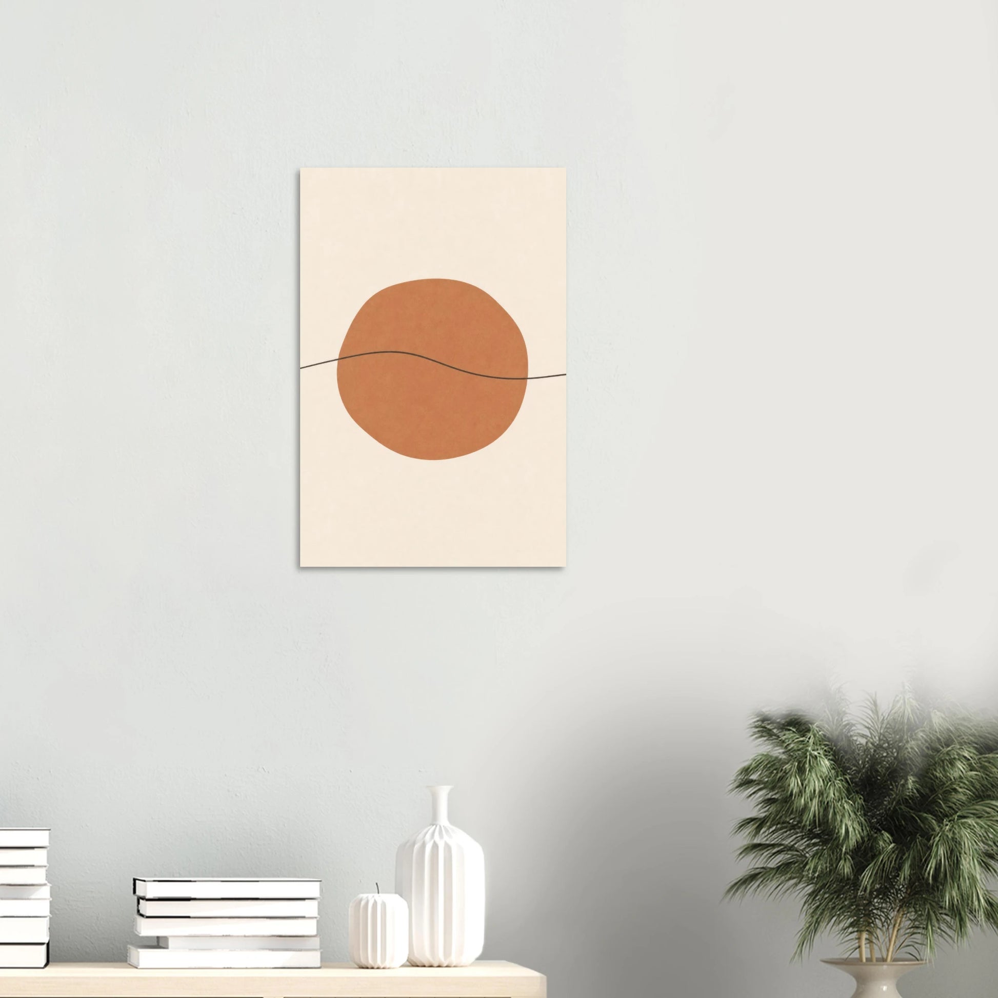 Terracotta Sun & Line nursery print on a white wall above a shelf with books and vases